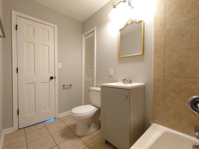 bathroom featuring tile patterned flooring, baseboards, vanity, and toilet