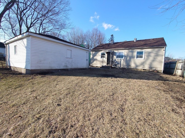 back of house with a yard and fence