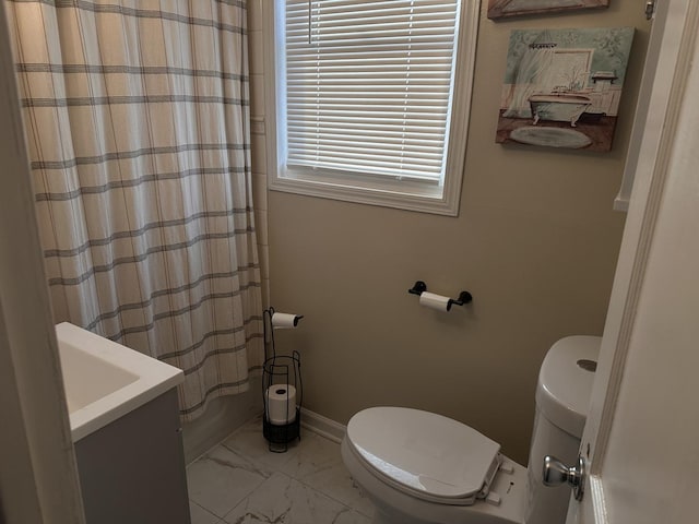 bathroom featuring vanity, toilet, and walk in shower