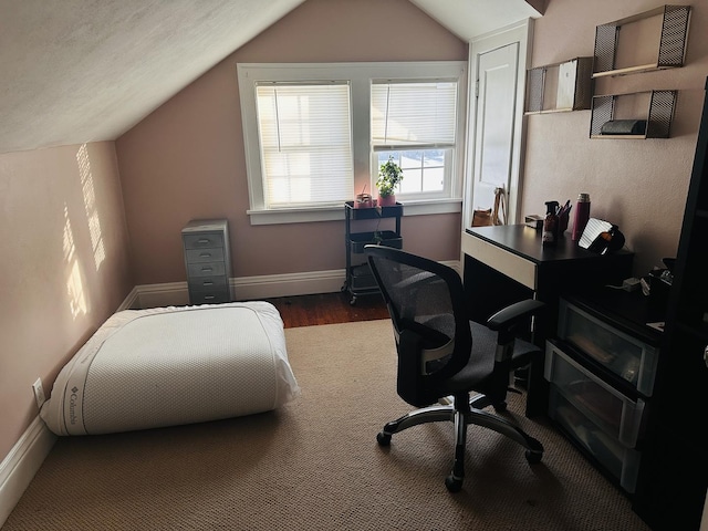 home office featuring vaulted ceiling and dark hardwood / wood-style flooring