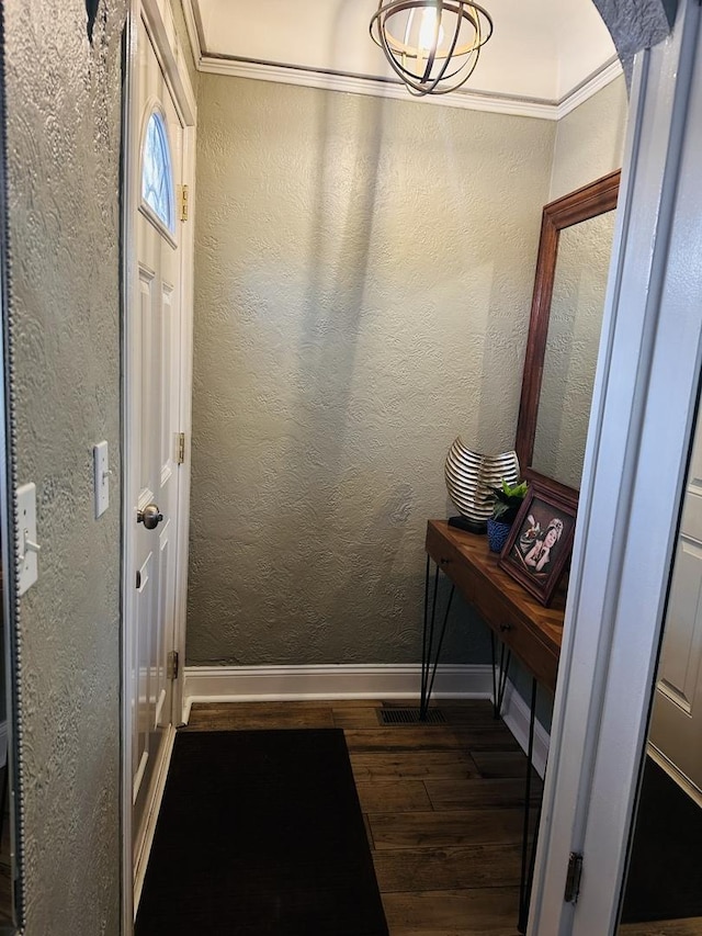 doorway to outside featuring crown molding and dark hardwood / wood-style floors