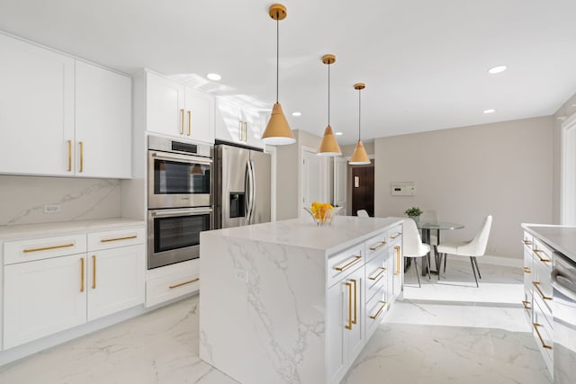 kitchen featuring marble finish floor, appliances with stainless steel finishes, white cabinets, and decorative light fixtures