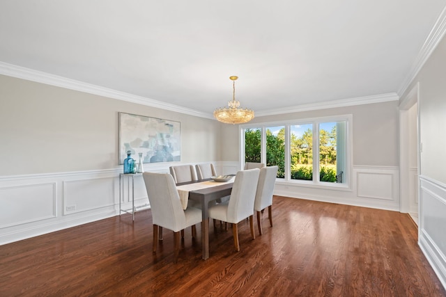 dining room featuring a notable chandelier, crown molding, a wainscoted wall, and wood finished floors