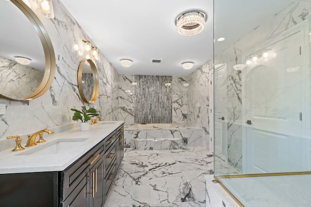 full bathroom featuring stone wall, a marble finish shower, a sink, tile walls, and marble finish floor