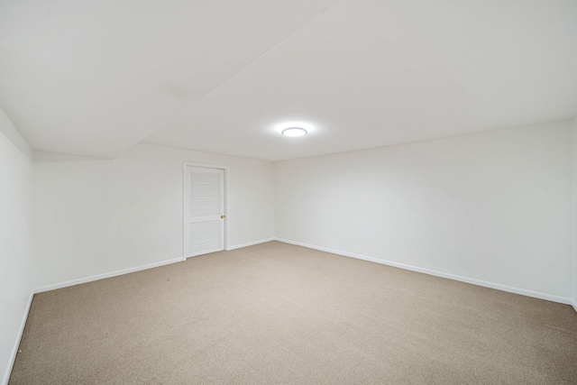 empty room with baseboards and light colored carpet