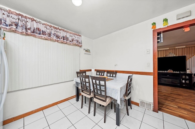 dining area featuring light tile patterned flooring, visible vents, and baseboards