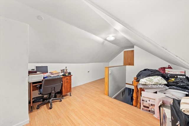 office area with lofted ceiling, baseboards, and wood finished floors