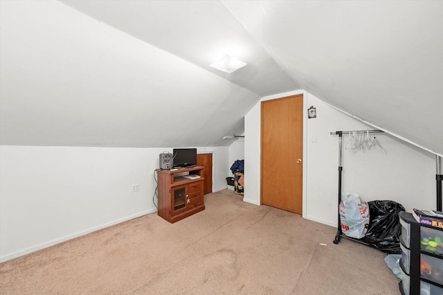 bonus room with baseboards, vaulted ceiling, and carpet flooring