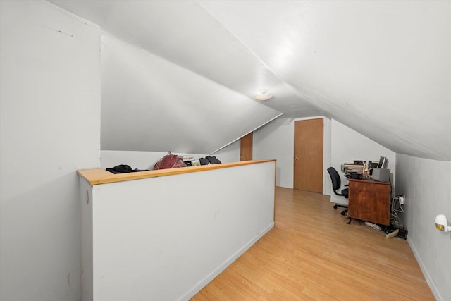 office area featuring vaulted ceiling and light wood-style floors