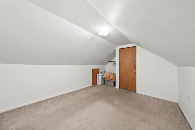 bonus room with carpet floors, vaulted ceiling, and baseboards