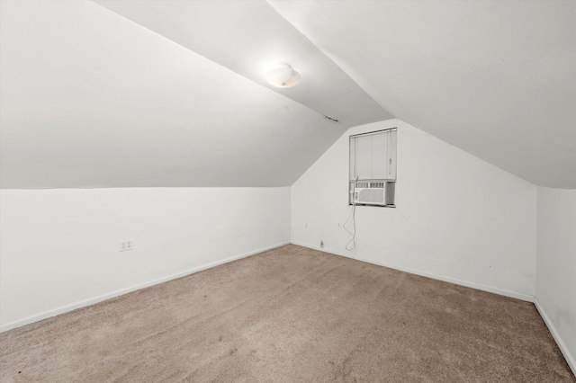 bonus room with carpet floors, cooling unit, vaulted ceiling, and baseboards