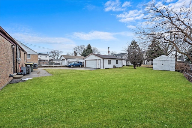 view of yard featuring a garage and an outdoor structure