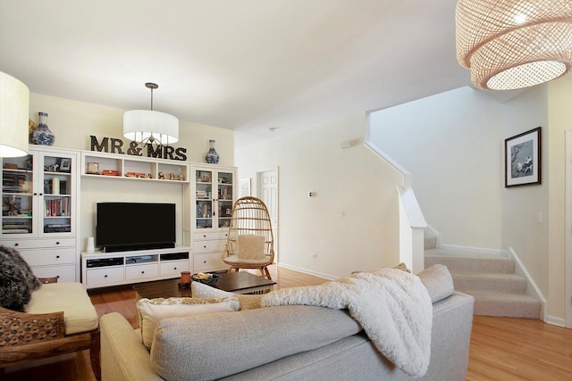 living area with light wood finished floors, stairs, and baseboards