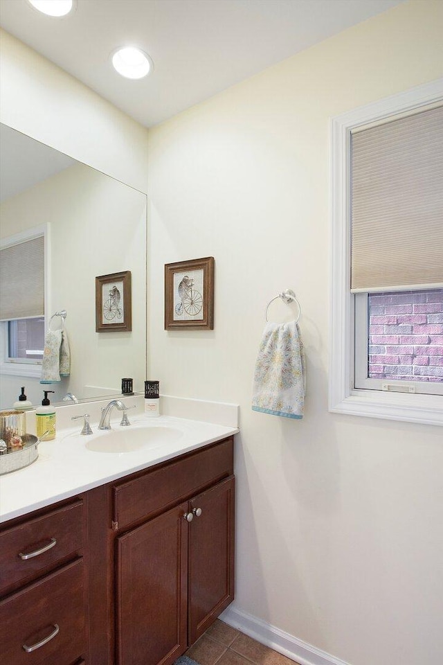 bathroom with tile patterned flooring, vanity, and baseboards