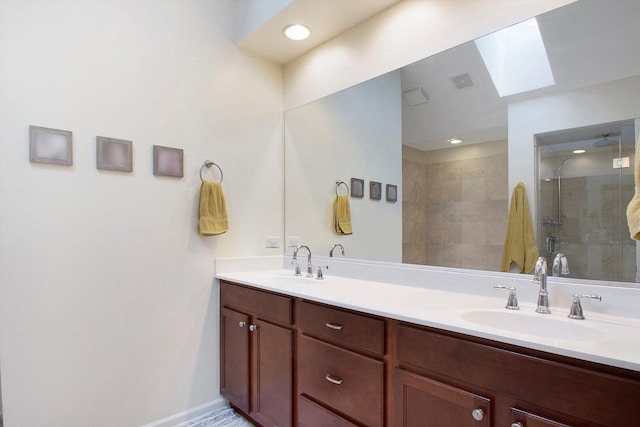 full bathroom featuring visible vents, a shower stall, a skylight, and a sink