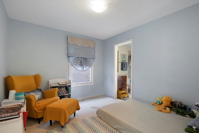 bedroom with visible vents, baseboards, light colored carpet, and ensuite bath