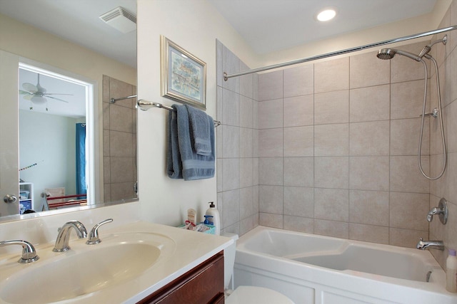 full bathroom with visible vents, toilet, vanity, and  shower combination