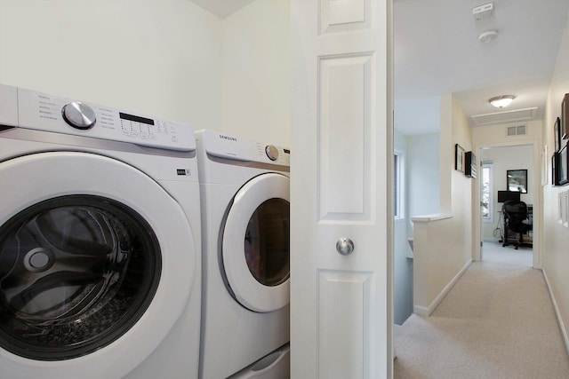 laundry room featuring visible vents, baseboards, laundry area, light carpet, and independent washer and dryer