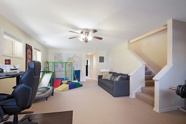 office space with baseboards, a ceiling fan, and carpet floors