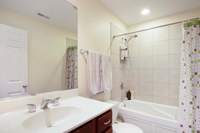 bathroom with vanity, toilet, visible vents, and shower / tub combo with curtain