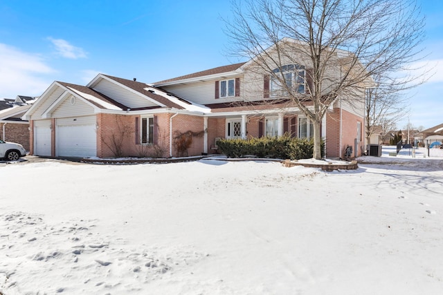 view of front property with a garage and central air condition unit