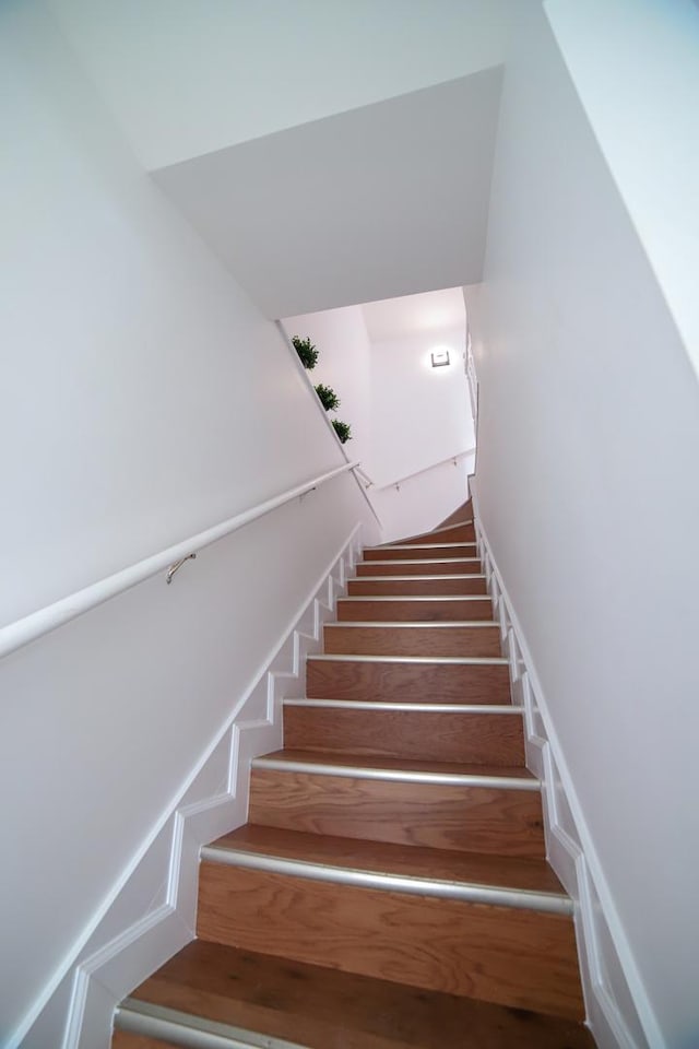 stairway with wood finished floors