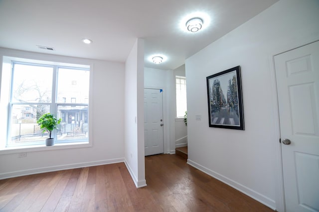 interior space featuring dark wood-style floors, a wealth of natural light, and visible vents