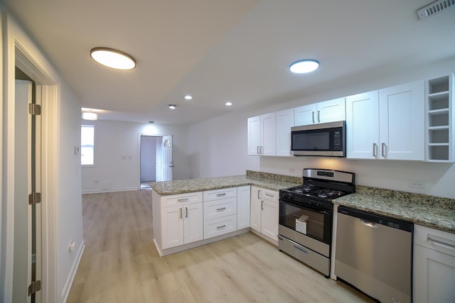 kitchen with open shelves, visible vents, appliances with stainless steel finishes, white cabinets, and a peninsula