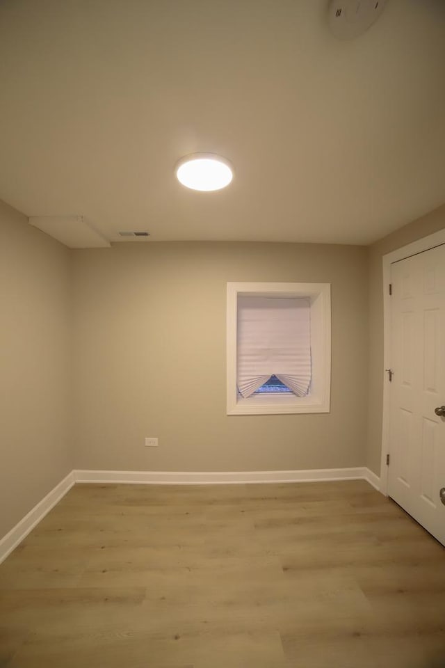 interior space with light wood-style floors, visible vents, and baseboards