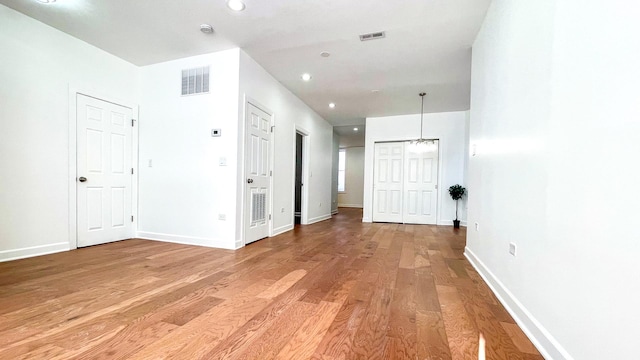 interior space featuring recessed lighting, wood finished floors, visible vents, and baseboards