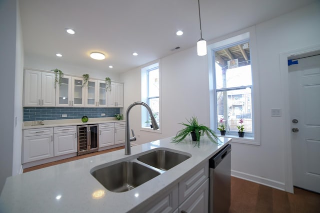 kitchen with dishwasher, wine cooler, glass insert cabinets, hanging light fixtures, and white cabinetry