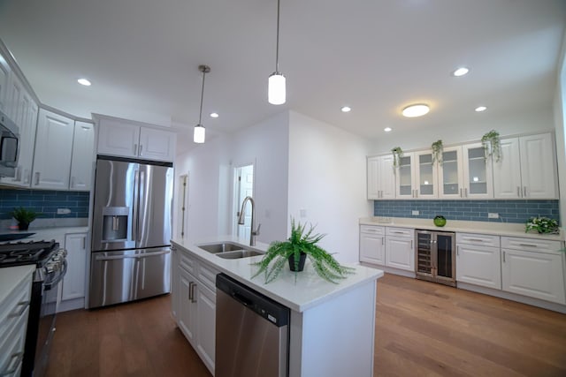 kitchen featuring glass insert cabinets, white cabinetry, appliances with stainless steel finishes, and light countertops