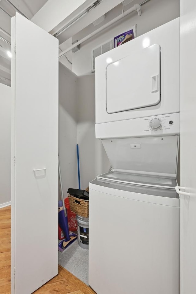 laundry area featuring stacked washer / drying machine