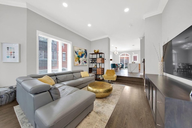 living room featuring a chandelier, ornamental molding, dark wood finished floors, and recessed lighting