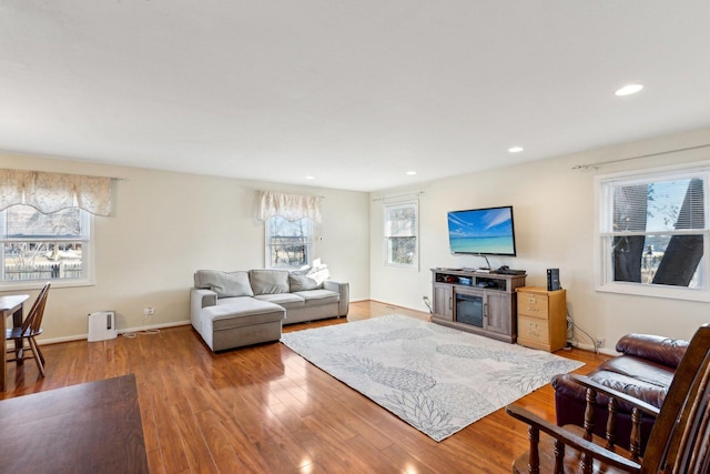 living room with recessed lighting, baseboards, and wood finished floors