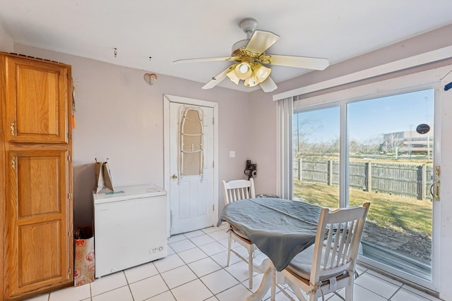 dining room with a ceiling fan and light tile patterned floors