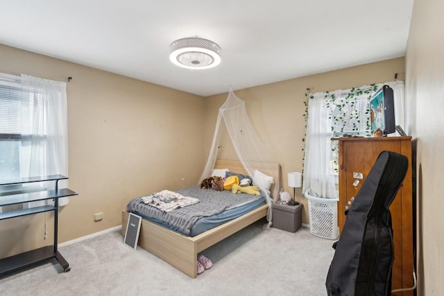 bedroom featuring carpet and baseboards