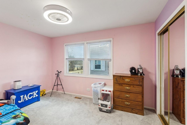 interior space with carpet flooring, visible vents, and baseboards