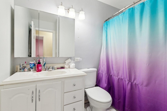 bathroom featuring toilet, a shower with curtain, and vanity