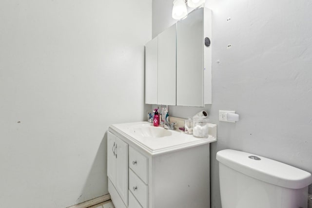 bathroom featuring toilet and vanity