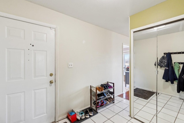 interior space with light tile patterned floors and a closet