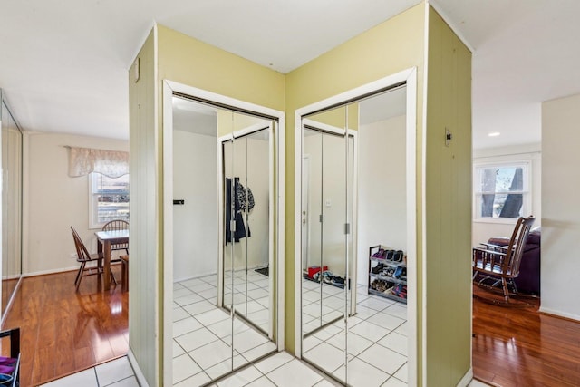 hallway with light wood-type flooring and a wealth of natural light