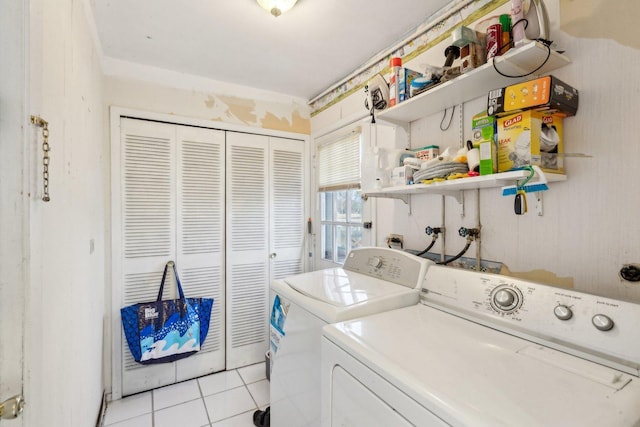 laundry area featuring laundry area, light tile patterned flooring, and washing machine and clothes dryer