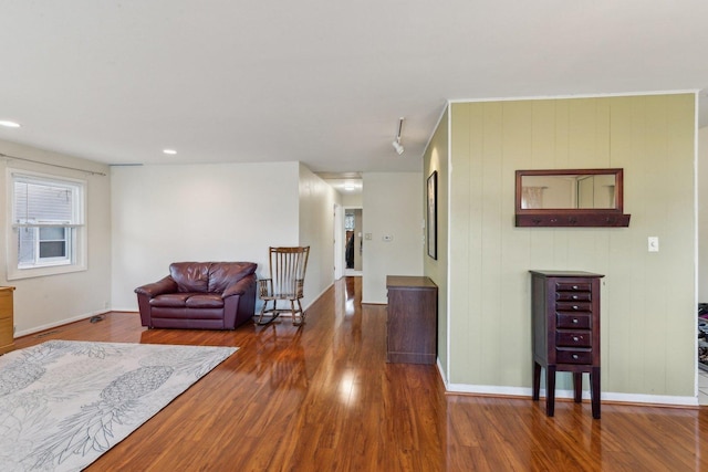 living area featuring baseboards and wood finished floors