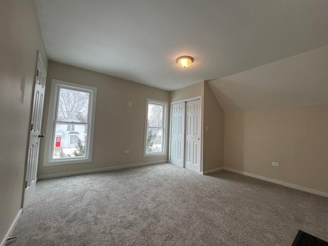 bonus room with carpet flooring, vaulted ceiling, and baseboards