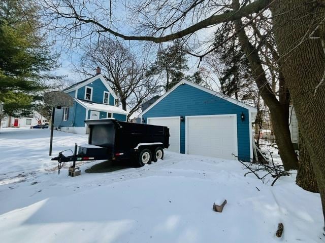 exterior space with a garage and an outdoor structure