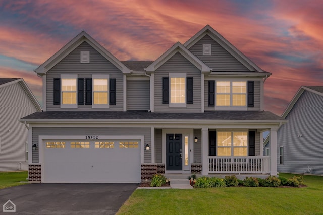 craftsman inspired home featuring a garage and a lawn