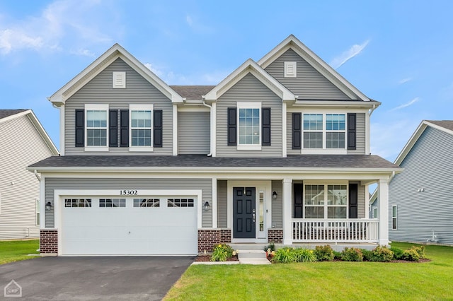 craftsman house with a front lawn and a garage