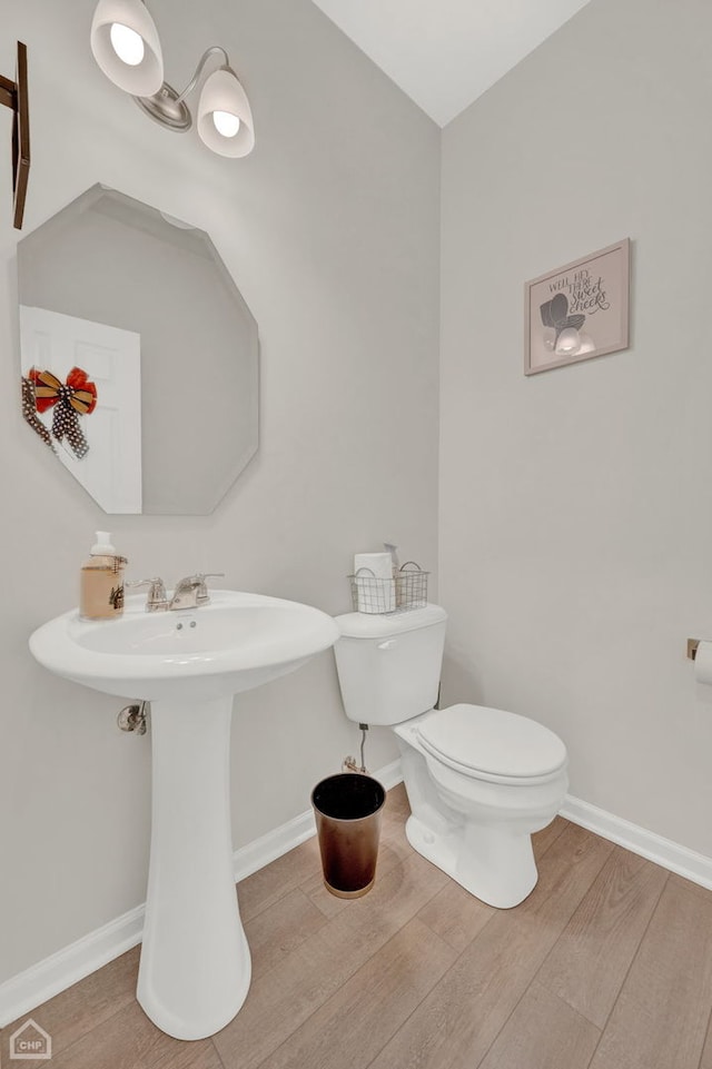 bathroom featuring toilet and hardwood / wood-style floors