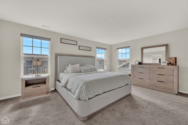 bedroom featuring light colored carpet